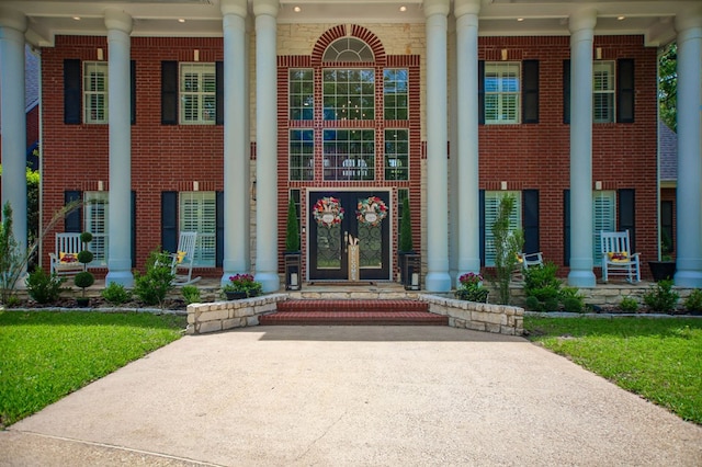 486 Brookwood Dr, Diboll, TX 75941 - doorway to property with brick siding and covered porch
