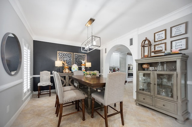 486 Brookwood Dr, Diboll, TX 75941 - dining room featuring visible vents, ornamental molding, light tile patterned flooring, baseboards, and arched walkways