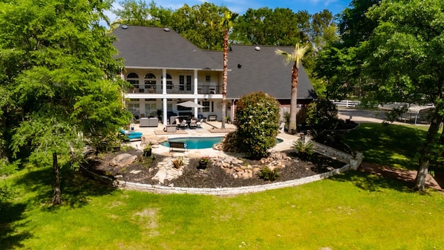 486 Brookwood Dr, Diboll, TX 75941 - back of house featuring a yard, a balcony, a patio area, and an outdoor pool