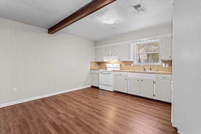 kitchen featuring sink, wood-type flooring, beamed ceiling, white stove, and white cabinetry