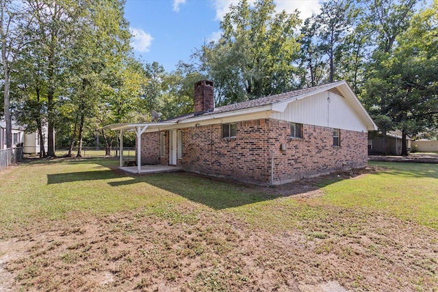 view of side of property with a yard