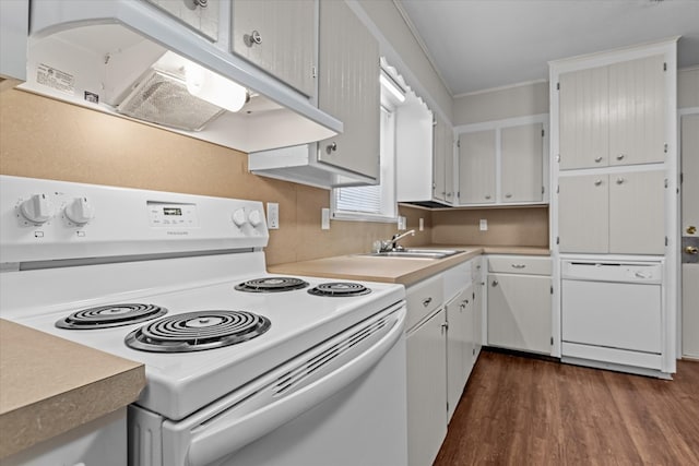 kitchen with dark hardwood / wood-style floors, sink, white appliances, and ornamental molding