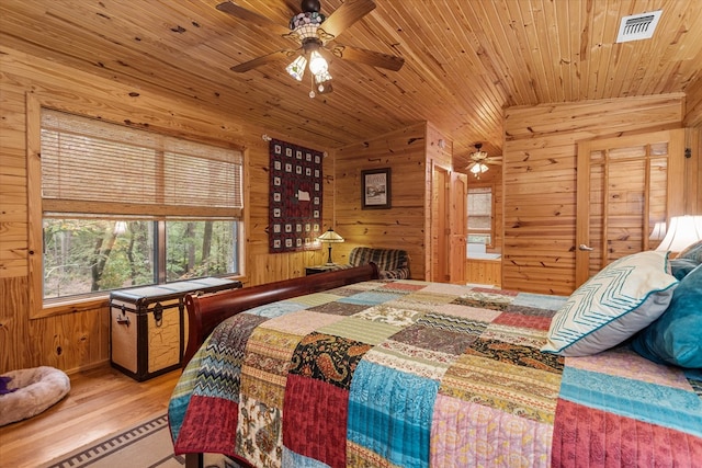 bedroom featuring wooden walls, hardwood / wood-style floors, wooden ceiling, and vaulted ceiling