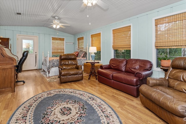 living room featuring hardwood / wood-style flooring, vaulted ceiling, and ceiling fan