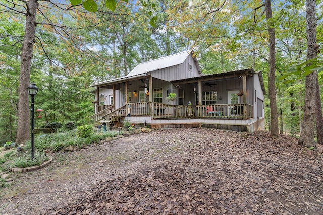 back of property featuring ceiling fan and a porch