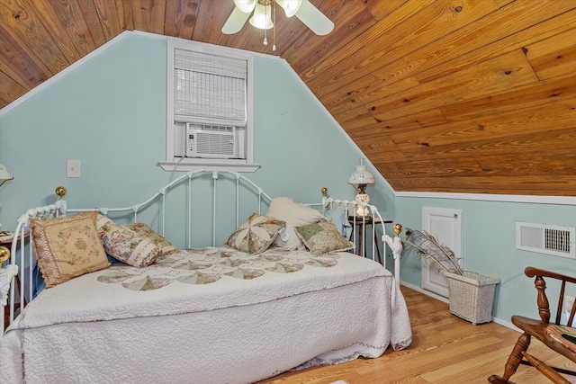 bedroom with wooden ceiling, cooling unit, vaulted ceiling, ceiling fan, and light hardwood / wood-style floors