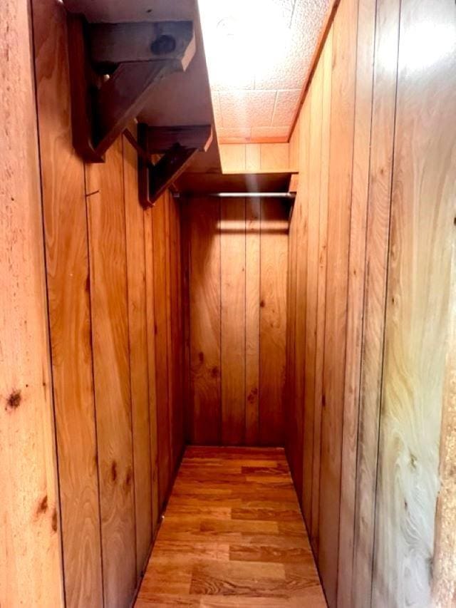 walk in closet featuring light hardwood / wood-style flooring