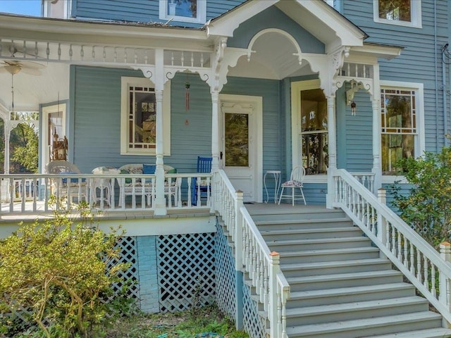 property entrance with ceiling fan and a porch