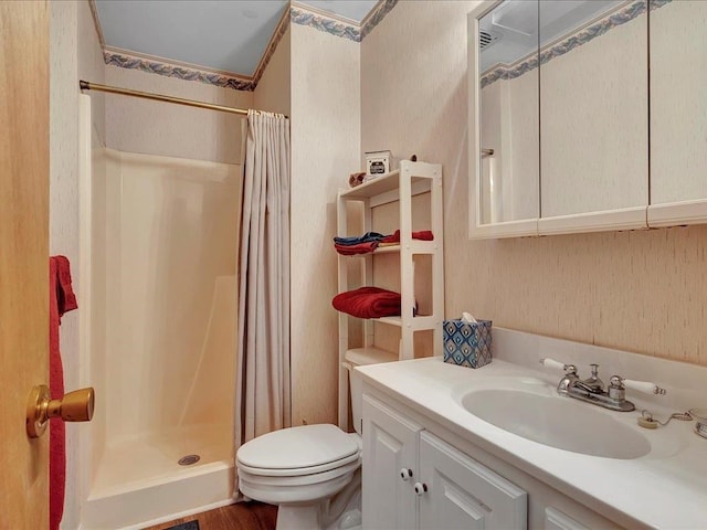 bathroom featuring hardwood / wood-style flooring, vanity, curtained shower, and toilet