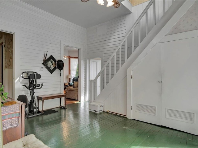 foyer entrance with a towering ceiling, hardwood / wood-style flooring, and ceiling fan