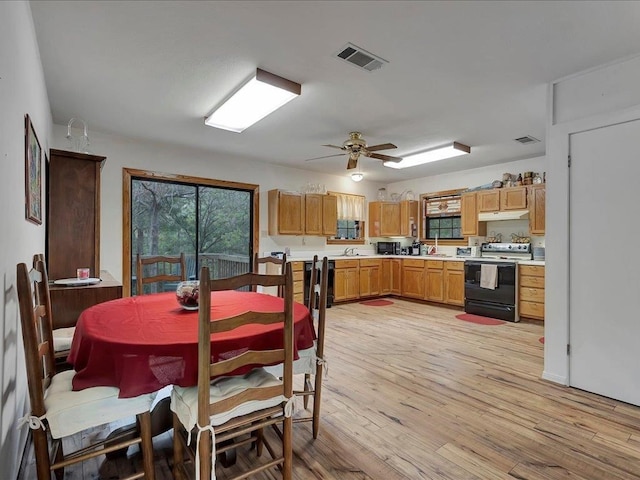 dining area featuring ceiling fan and light wood-type flooring