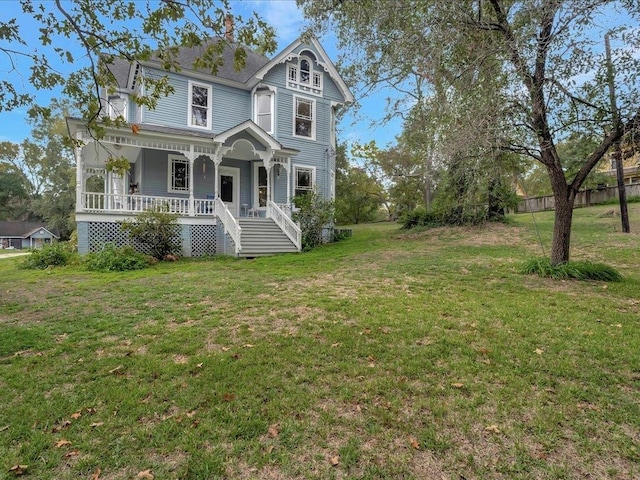 victorian home with a porch and a front yard