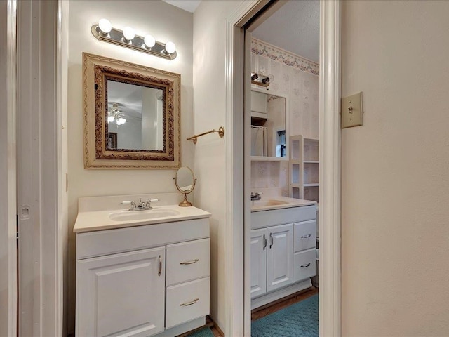 bathroom featuring hardwood / wood-style flooring, vanity, and ceiling fan