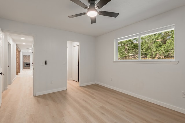 1311 Walnut Bend Dr, Lufkin, TX 75904 - unfurnished bedroom featuring light wood-style flooring, multiple windows, and ceiling fan