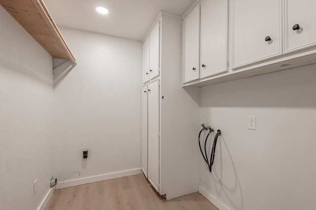 1311 Walnut Bend Dr, Lufkin, TX 75904 - laundry area with cabinet space, light wood-style flooring, hookup for a washing machine, and recessed lighting