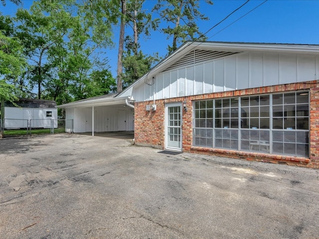 1304 Walnut Bend Dr, Lufkin, TX 75904 - view of side of property with brick siding, fence, an attached carport, and board and batten siding