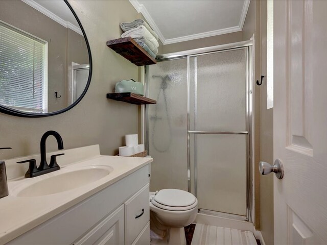 1304 Walnut Bend Dr, Lufkin, TX 75904 - full bathroom featuring a shower stall, vanity, ornamental molding, and toilet