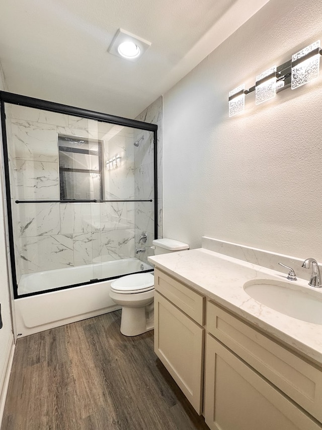 4 Columbia Ct, Lufkin, TX 75901 - full bath with wood finished floors, bath / shower combo with glass door, toilet, and vanity