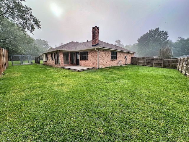 4 Columbia Ct, Lufkin, TX 75901 - rear view of property featuring a chimney, brick siding, a wooden deck, and roof with shingles