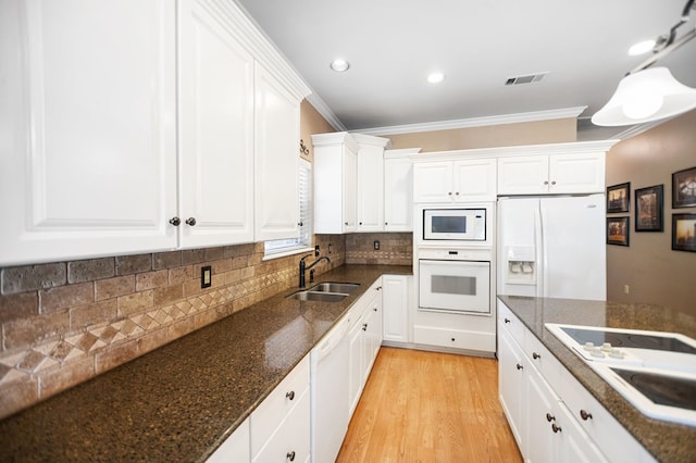 703 Shady Ln, Diboll, TX 75941 - kitchen featuring white appliances, a sink, crown molding, white cabinetry, and light wood-style floors