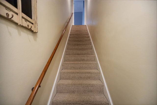 703 Shady Ln, Diboll, TX 75941 - stairway featuring baseboards