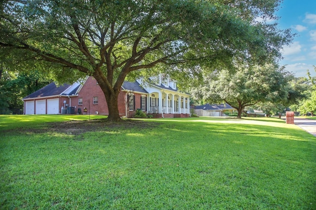 703 Shady Ln, Diboll, TX 75941 - view of grassy yard featuring a porch and a garage