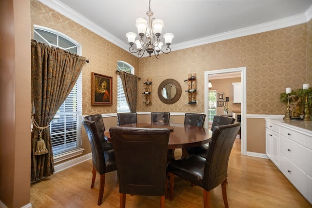 703 Shady Ln, Diboll, TX 75941 - dining area with wallpapered walls, a chandelier, ornamental molding, and light wood finished floors