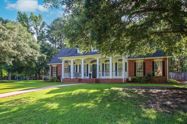703 Shady Ln, Diboll, TX 75941 - view of front facade with covered porch, brick siding, and a front yard