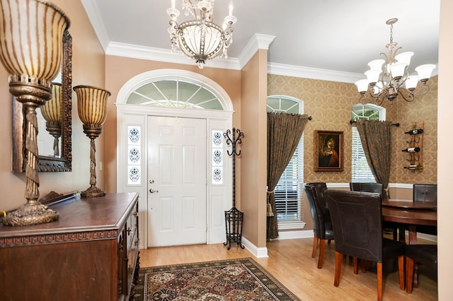 703 Shady Ln, Diboll, TX 75941 - foyer entrance with a chandelier, crown molding, wallpapered walls, light wood-style floors, and baseboards
