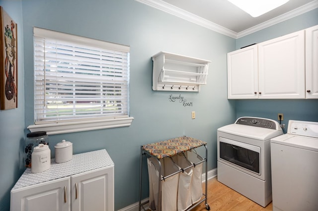 703 Shady Ln, Diboll, TX 75941 - washroom with cabinet space, independent washer and dryer, crown molding, light wood-type flooring, and baseboards