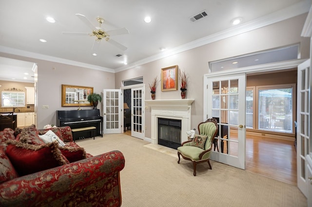 703 Shady Ln, Diboll, TX 75941 - living room with french doors, a ceiling fan, ornamental molding, a fireplace with flush hearth, and recessed lighting