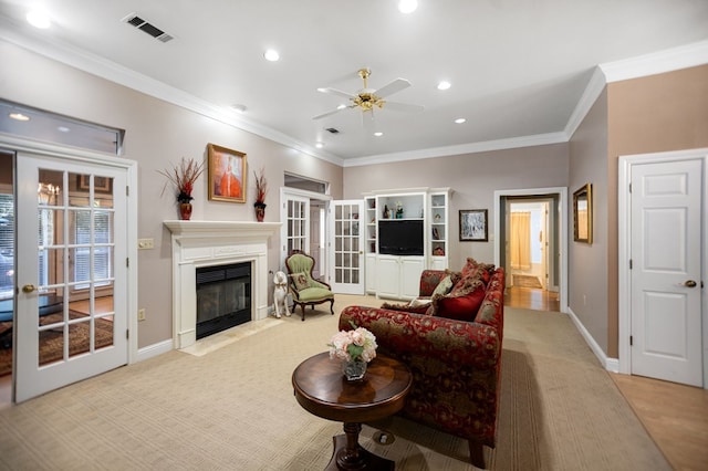 703 Shady Ln, Diboll, TX 75941 - living room featuring light carpet, ceiling fan, a fireplace with flush hearth, crown molding, and baseboards