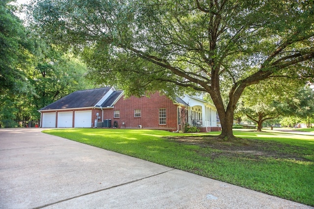 703 Shady Ln, Diboll, TX 75941 - view of side of property featuring driveway, brick siding, a lawn, an attached garage, and central AC unit