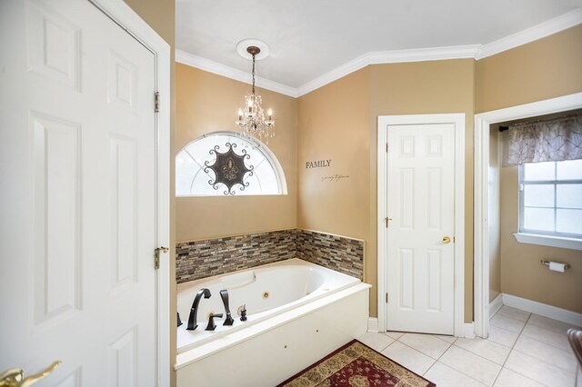 703 Shady Ln, Diboll, TX 75941 - bathroom featuring a chandelier, tile patterned flooring, ornamental molding, a jetted tub, and baseboards