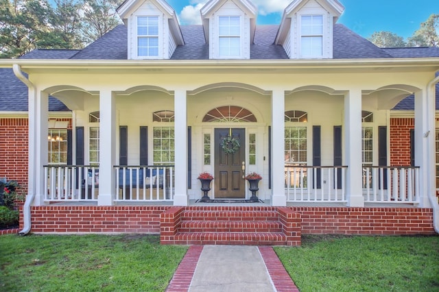 703 Shady Ln, Diboll, TX 75941 - view of exterior entry featuring covered porch and roof with shingles
