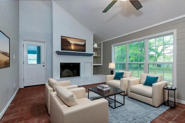 living room featuring plenty of natural light, baseboards, ceiling fan, and vaulted ceiling