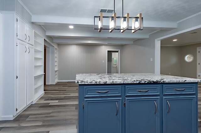 kitchen featuring white cabinets, an inviting chandelier, ornamental molding, dark wood-style floors, and blue cabinets