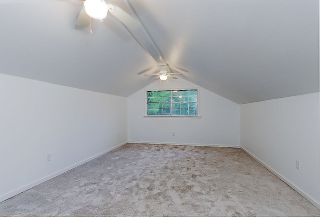 additional living space with ceiling fan, lofted ceiling with beams, baseboards, and carpet