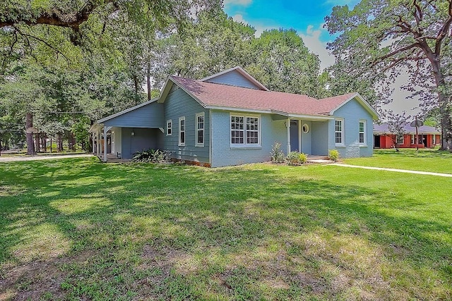 ranch-style home with a front lawn and brick siding