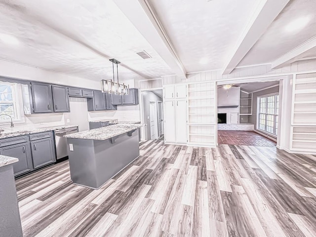 kitchen with light wood-type flooring, gray cabinets, and beam ceiling