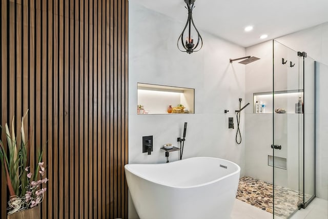 bathroom with tile patterned flooring and independent shower and bath