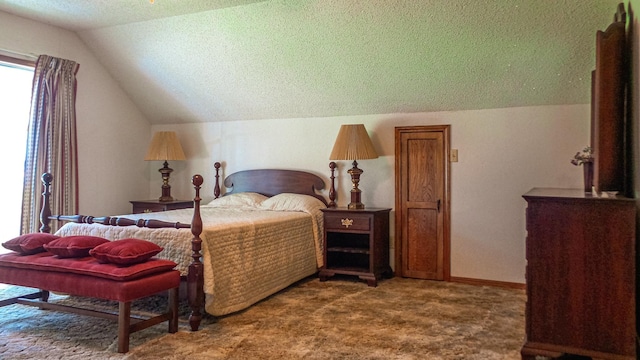 carpeted bedroom with vaulted ceiling and a textured ceiling