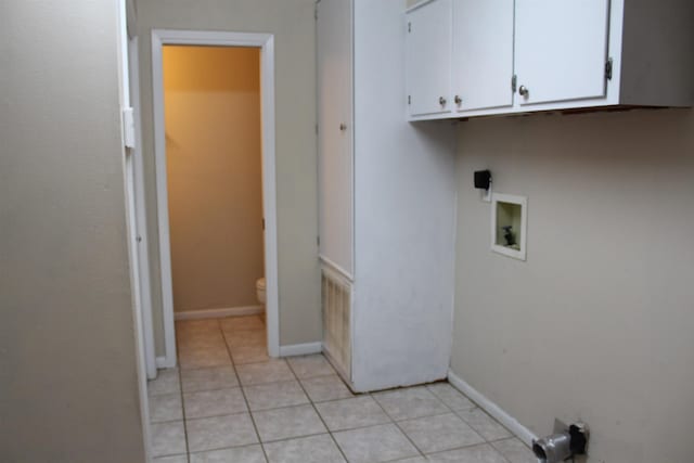 laundry area with light tile patterned floors, cabinets, and washer hookup