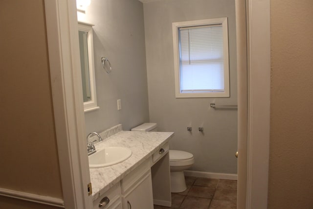 bathroom featuring tile patterned floors, vanity, and toilet