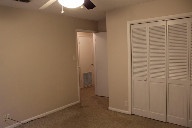 unfurnished bedroom with a closet, ceiling fan, and light colored carpet