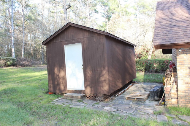 view of outbuilding with a lawn