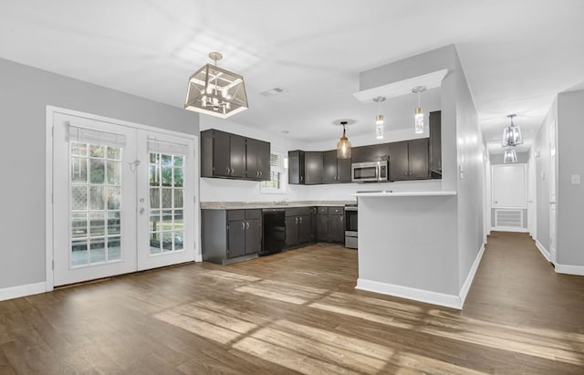 kitchen with an inviting chandelier, french doors, hardwood / wood-style flooring, decorative light fixtures, and stainless steel appliances