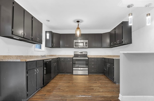 kitchen with stainless steel appliances, hanging light fixtures, dark wood-type flooring, and sink