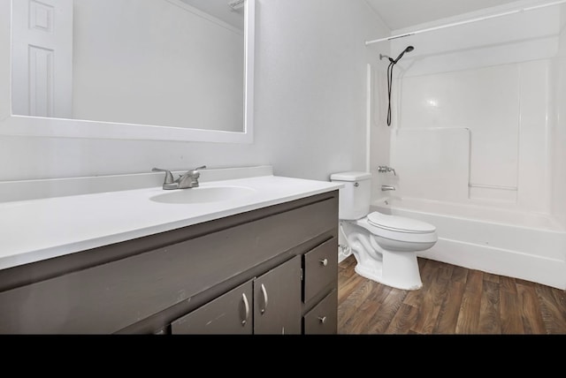 full bathroom with bathing tub / shower combination, vanity, wood-type flooring, and toilet