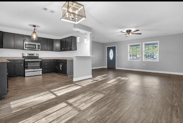 1411 Ryan Chapel Rd, Diboll, TX 75941 - kitchen with stainless steel appliances, light countertops, ceiling fan, dark wood finished floors, and hanging light fixtures